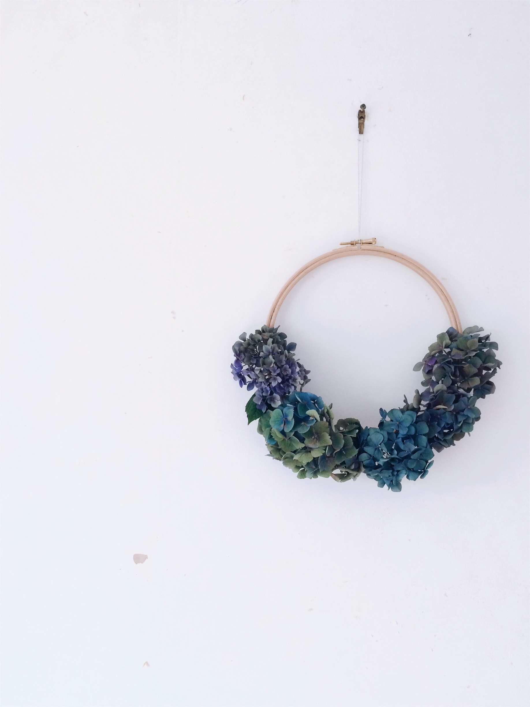 Finished hydrangea wreath hanging on wall